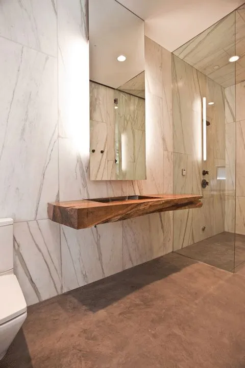 13-a-stone-slab-and-a-rough-wood-countertop-highlighted-with-lights-behind-the-mirror